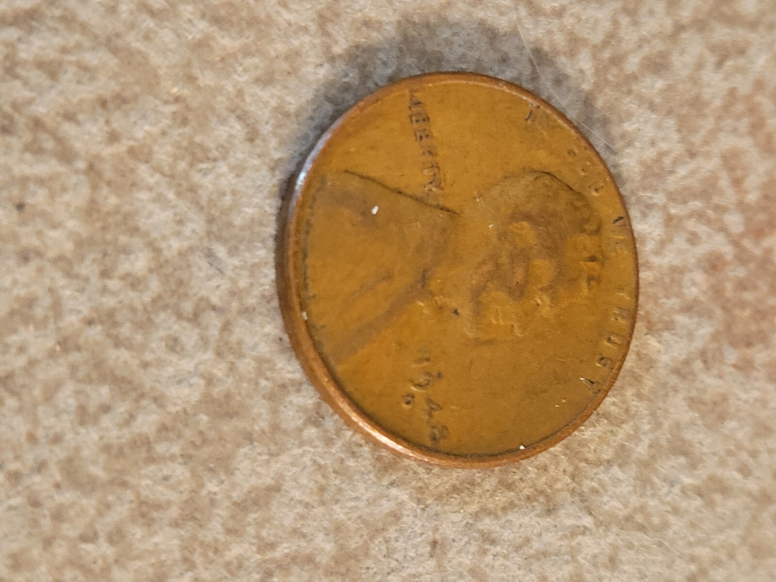 1944 No Mint wheat penny L error touching edge of rim