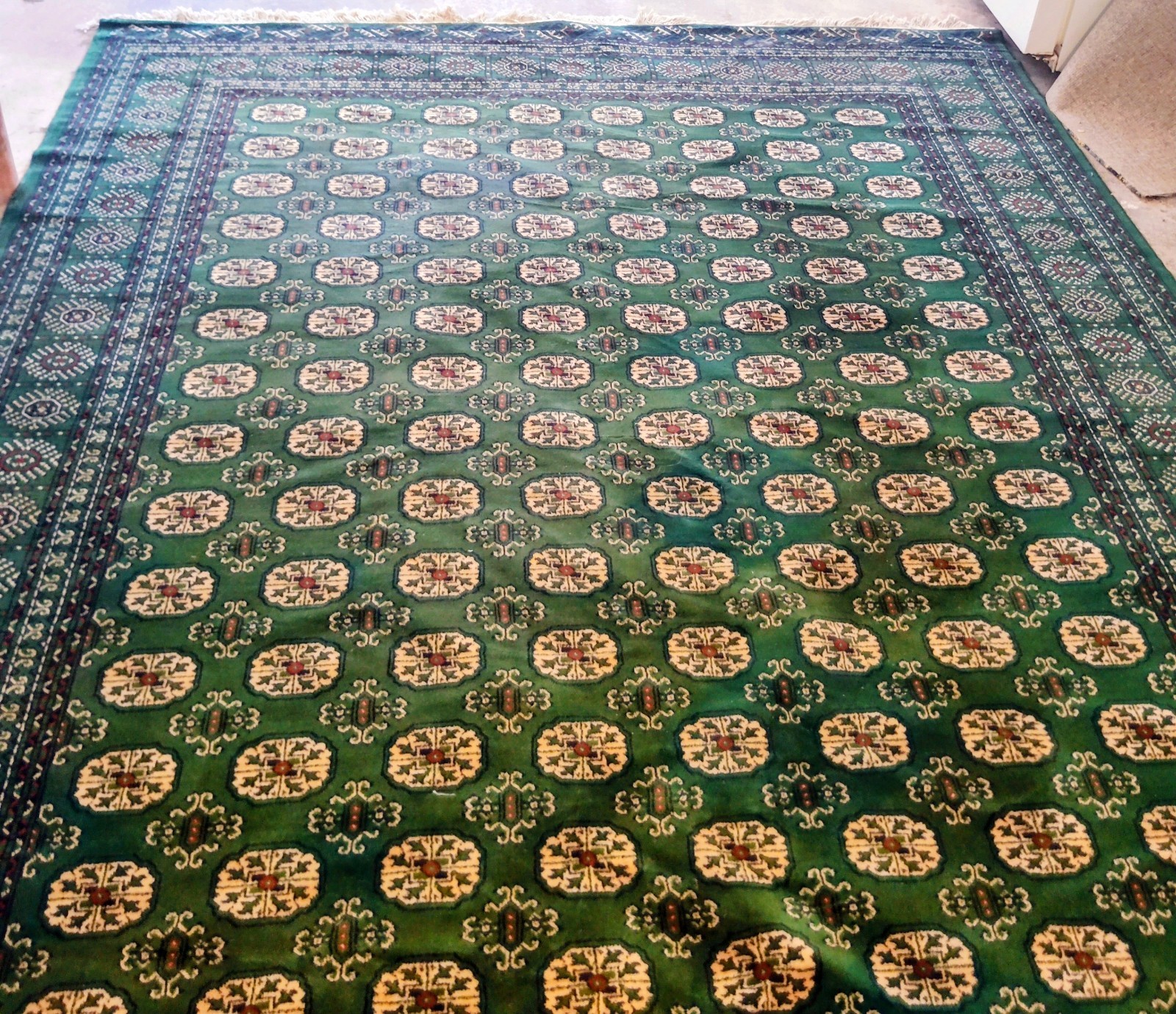 authentic green hand-knotted Bokhara rug “elephant’s footprint/Tekke gul pattern