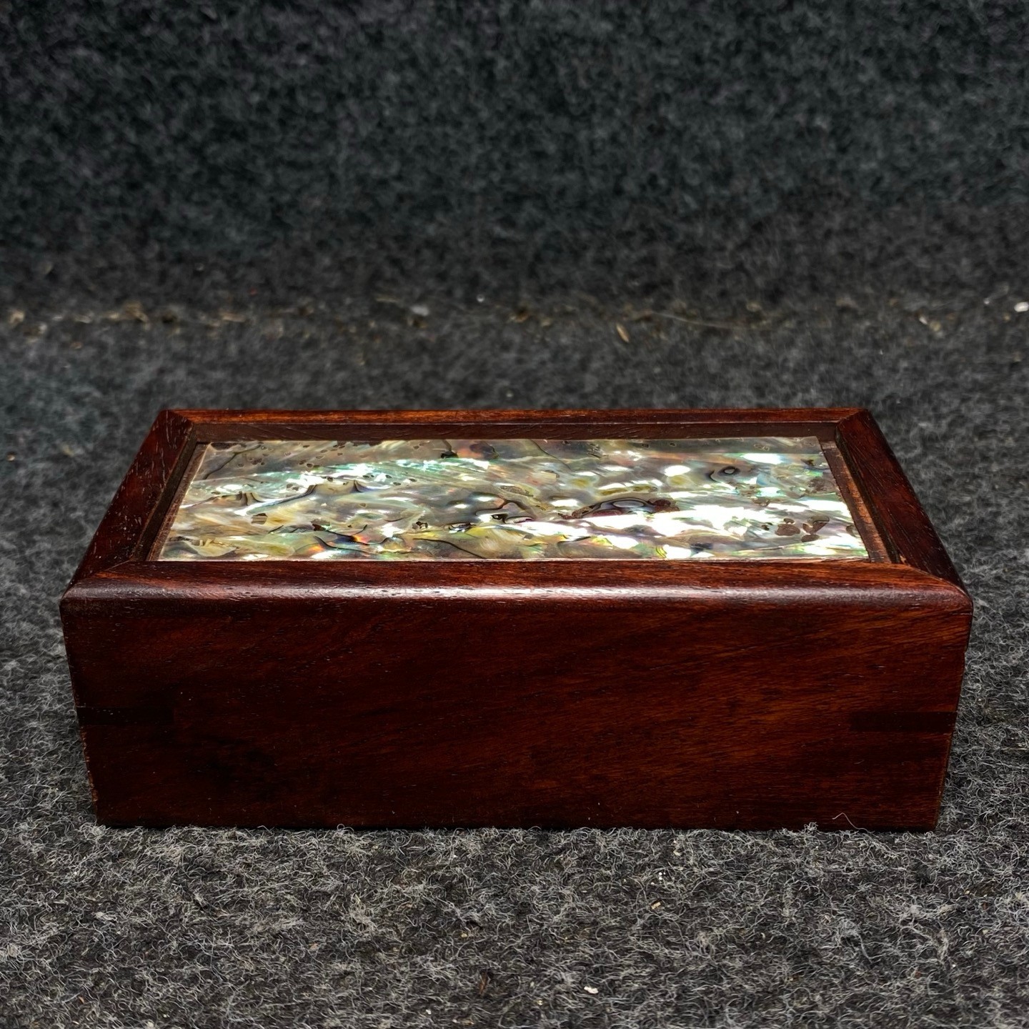 Pinestone bracelets are placed inside a rosewood inlaid with colorful shells box