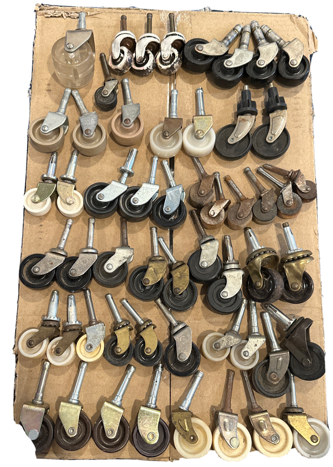 54 Assorted Vintage casters different sizes and materials from plastic to wood