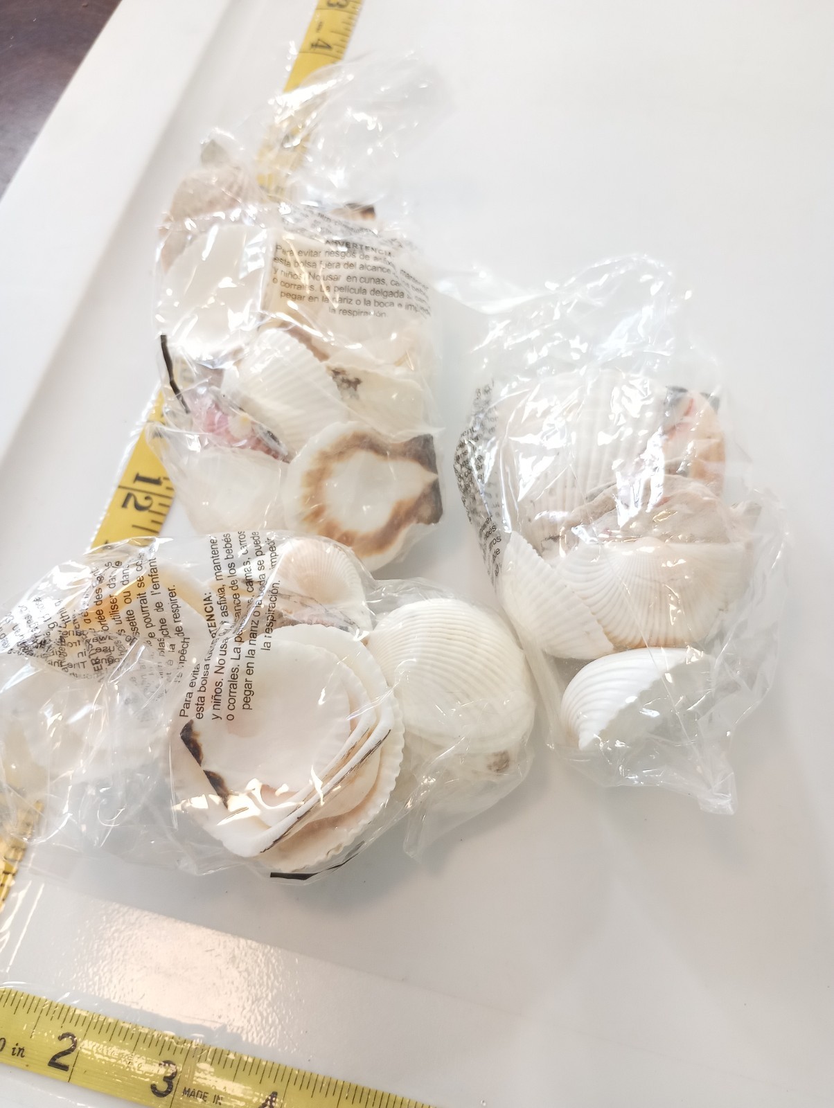 Small kraft lot-white seashells in bags sealed