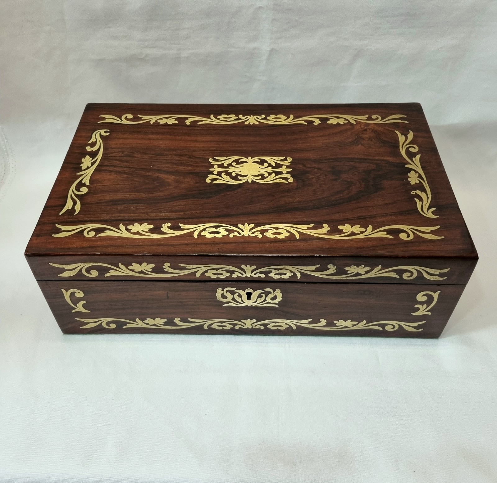 Large antique rosewood jewellery / trinket box inlaid with foliate brass details