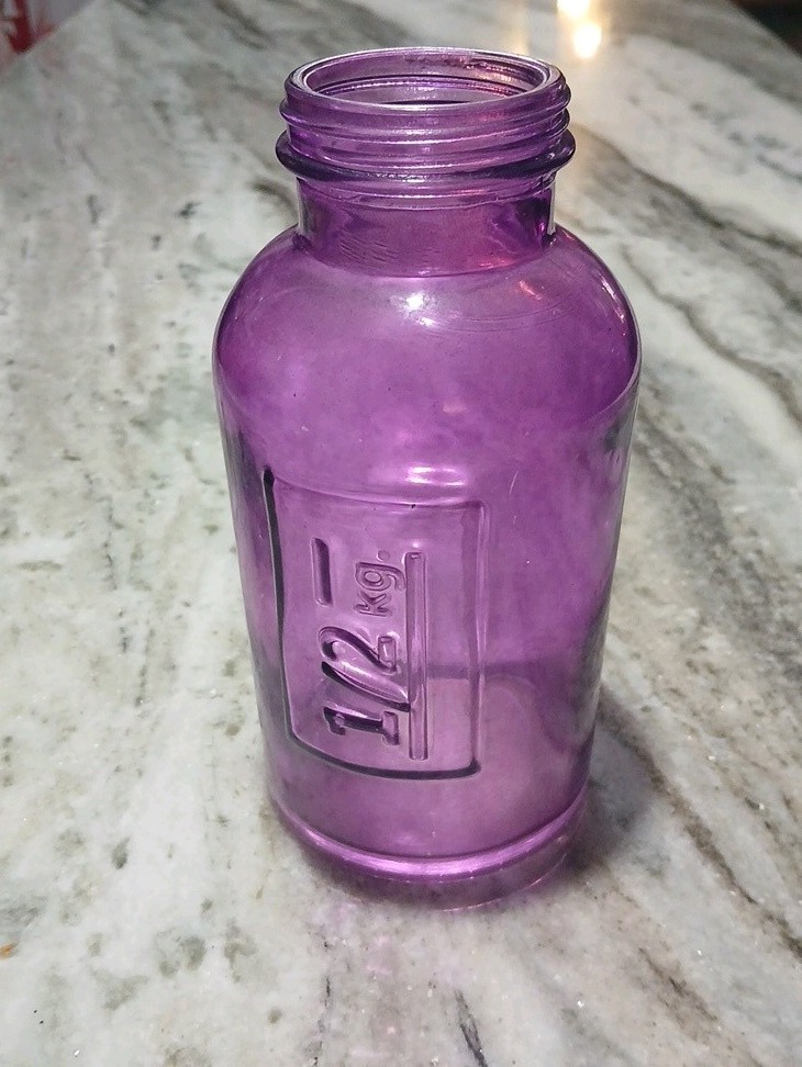 vintage purple Amathyst glass apothecary bottle. Embossed On Side With 1/2 Kg.
