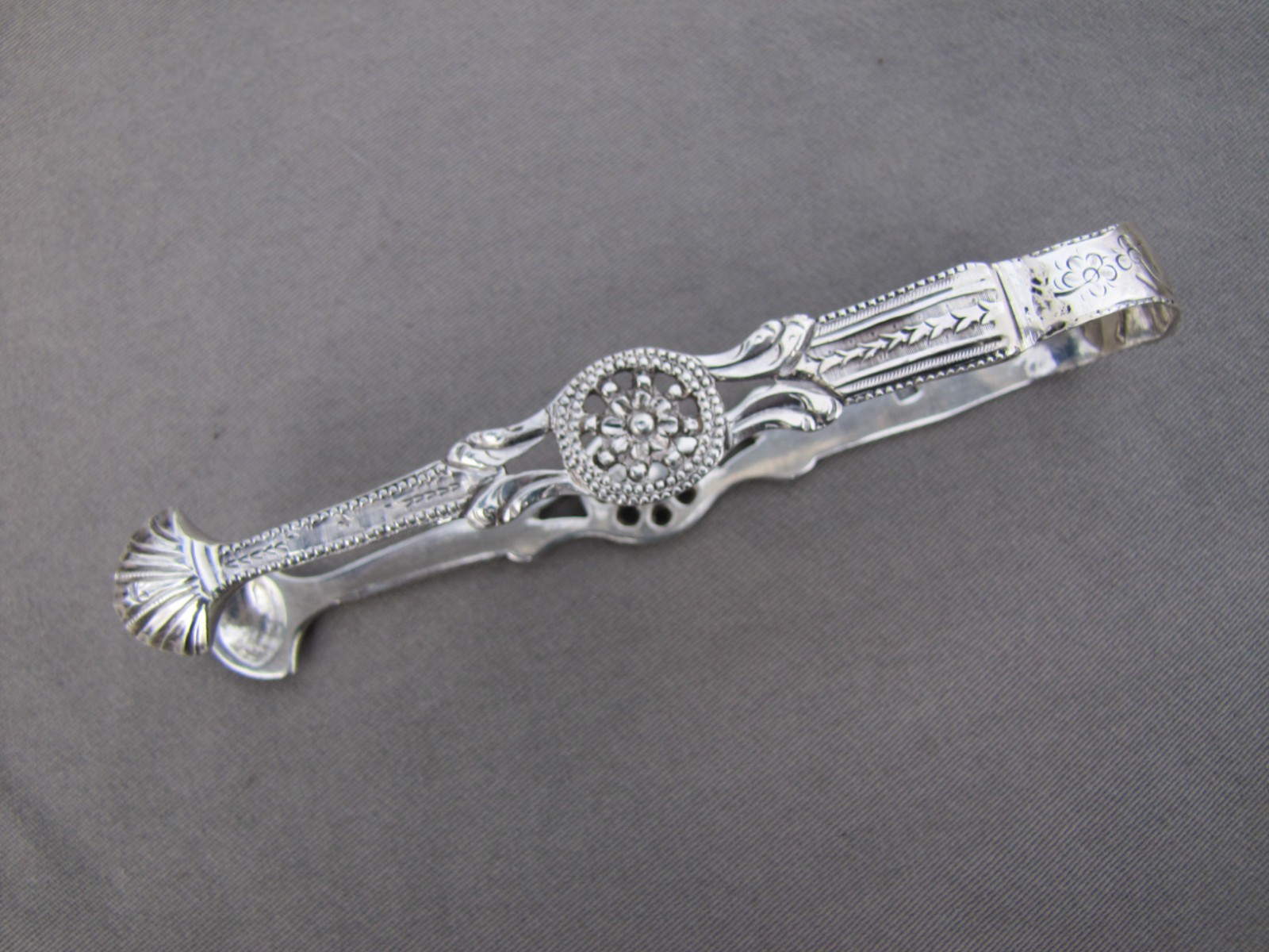 Antique sterling silver pierced design sugar tongs