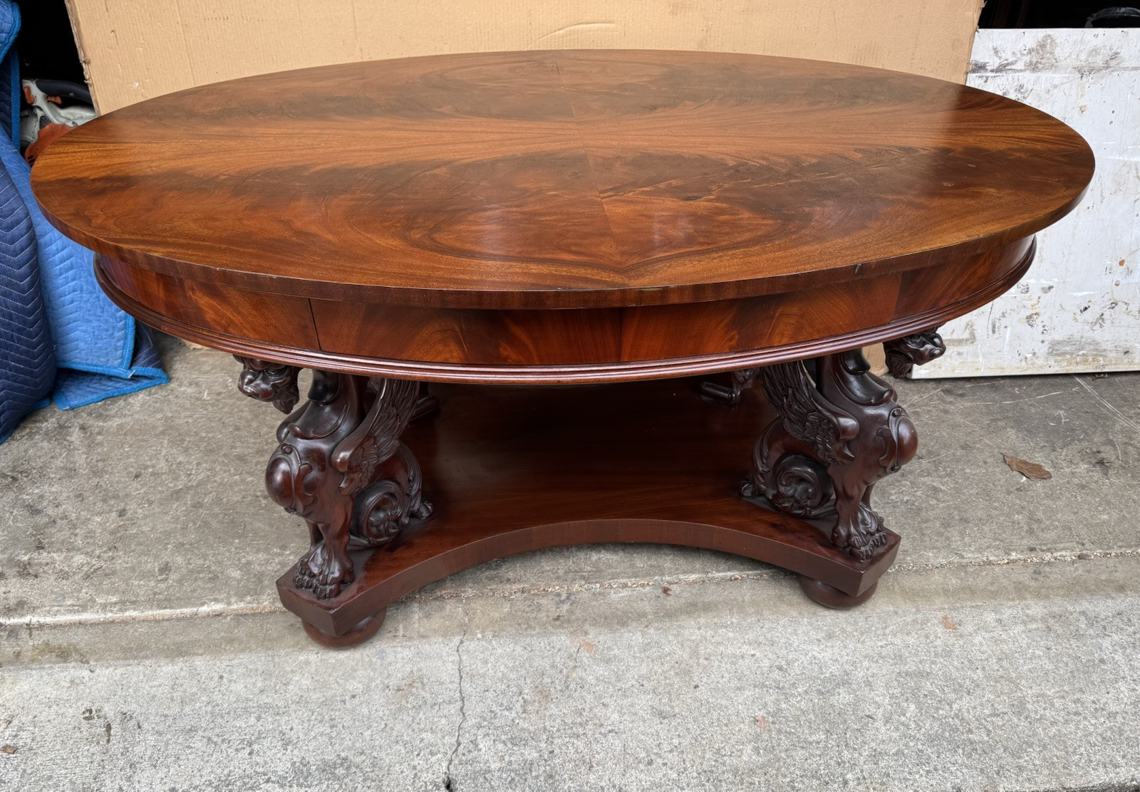R. J. HORNER CARVED MAHOGANY WING GRIFFIN OVAL LIBRARY TABLE