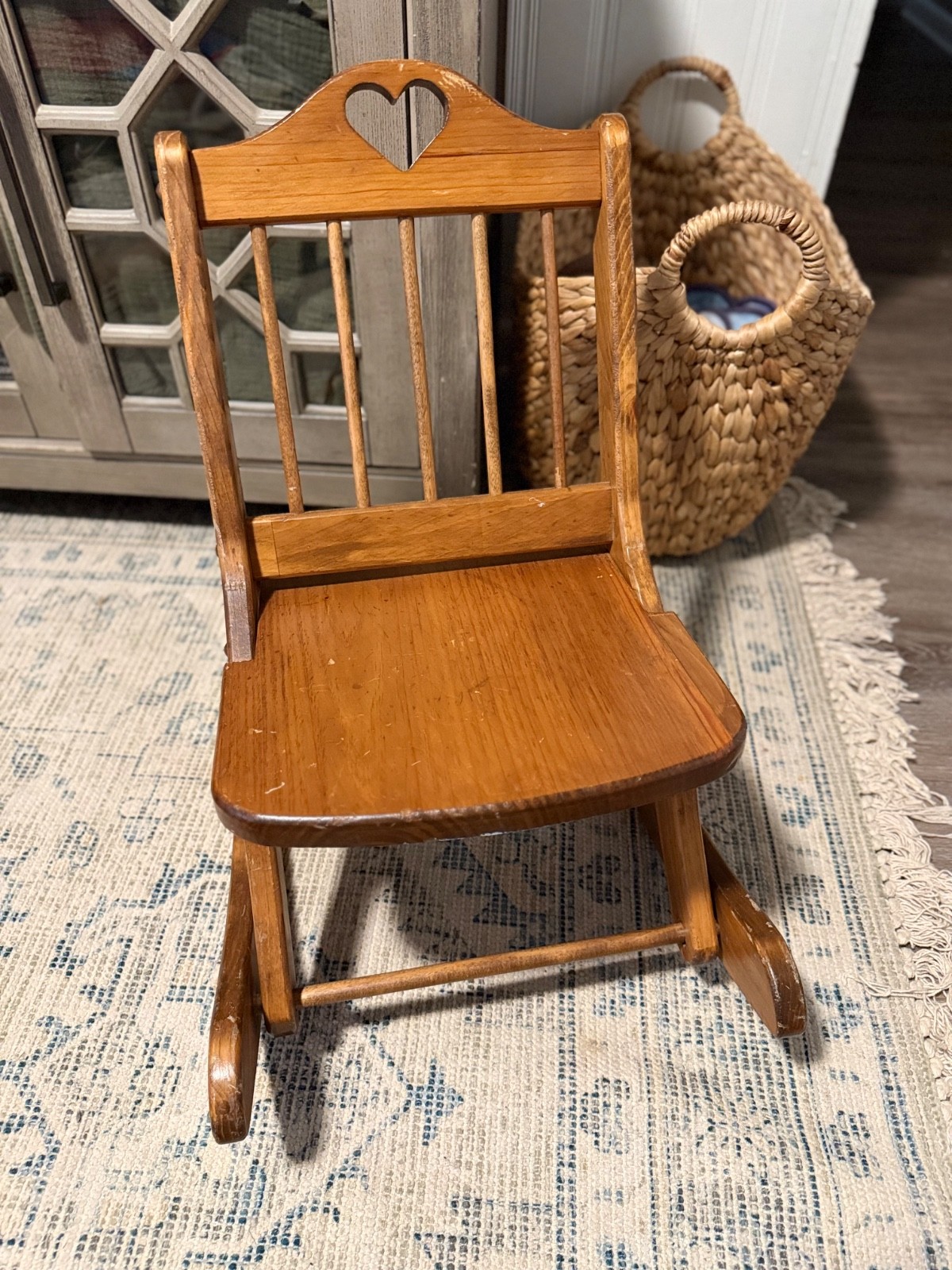 Vintage child-sized folding wooden rocking chair featuring a heart-shaped cutout