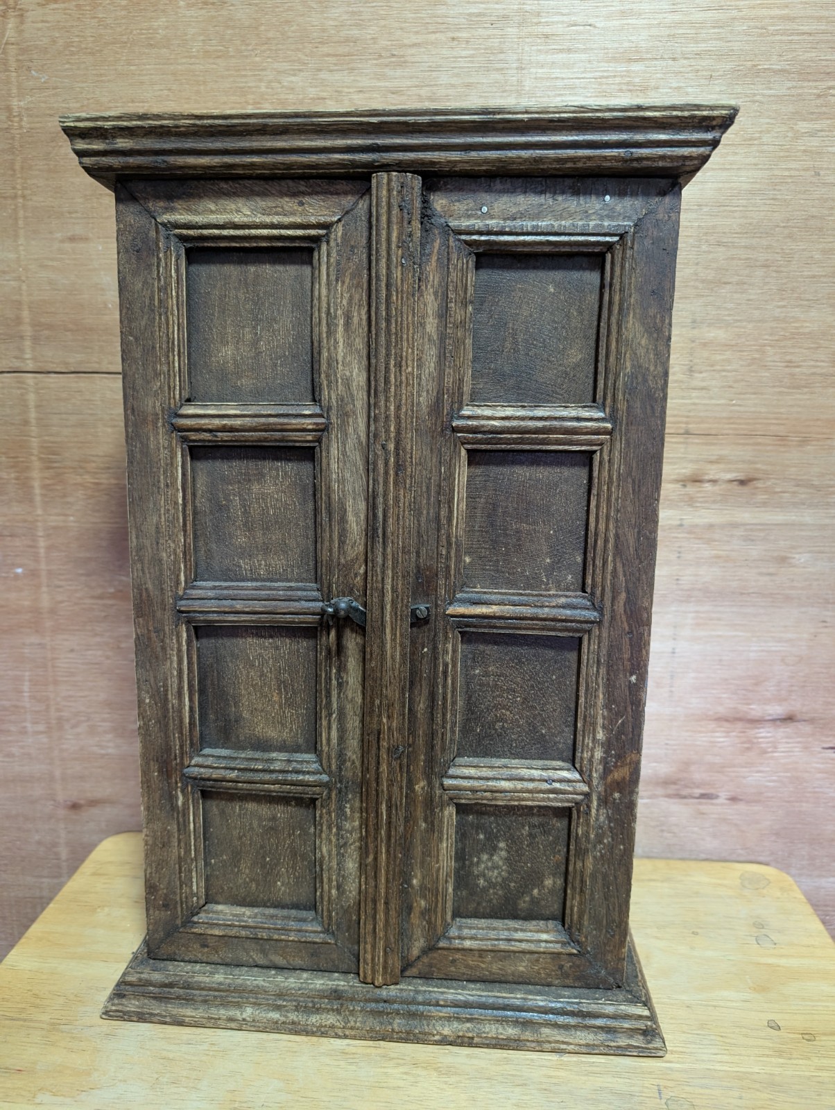small antique wooden cabinet, similar to a smokers cabinet or a miniature…