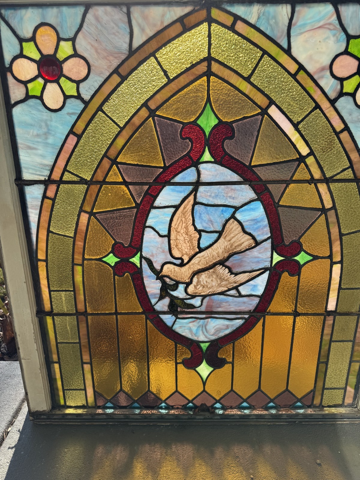 Dove of peace up and down stained glass window