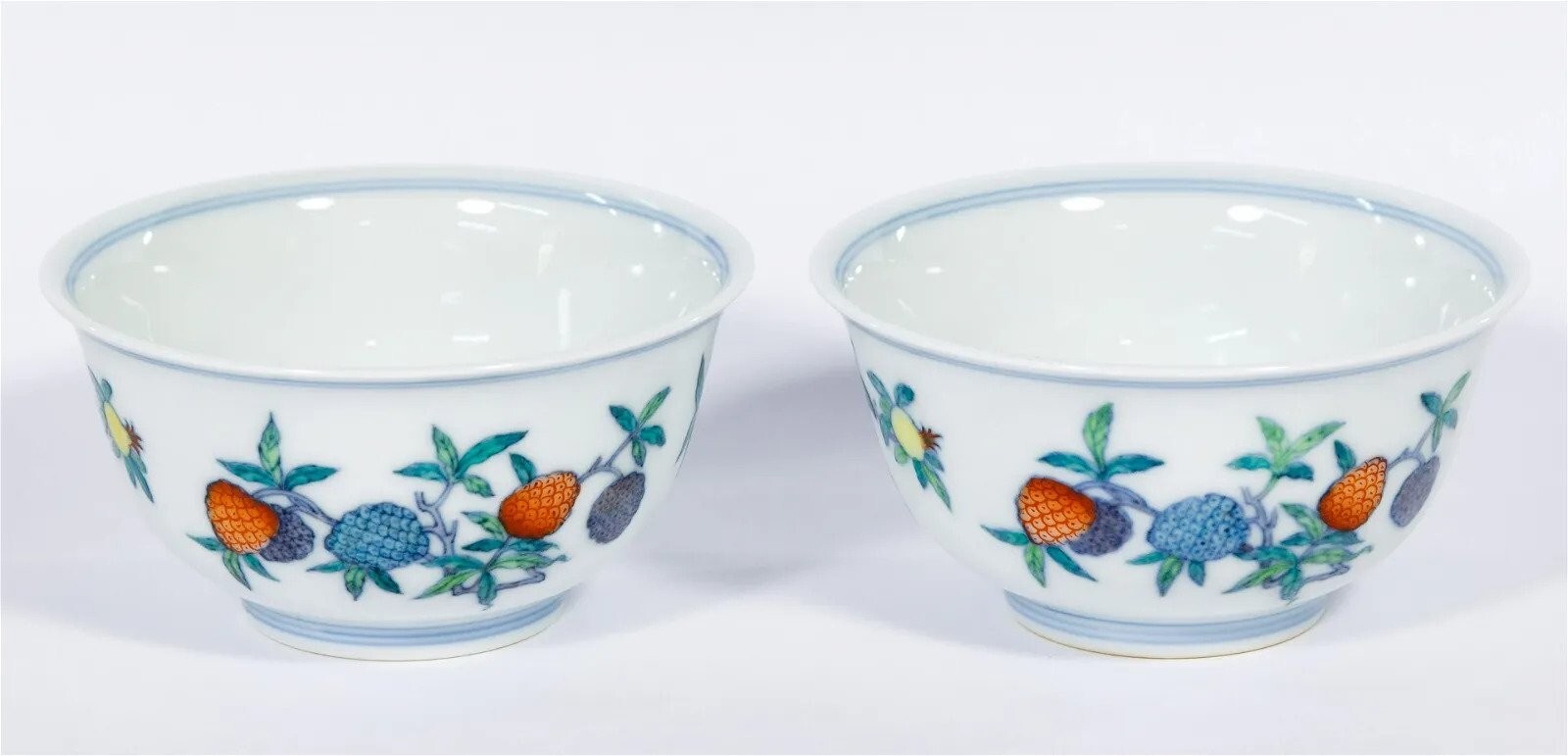 A PAIR OF CHINESE DOUCAI CUPS, YONGZHENG MARK AND OF A LATER PERIOD
