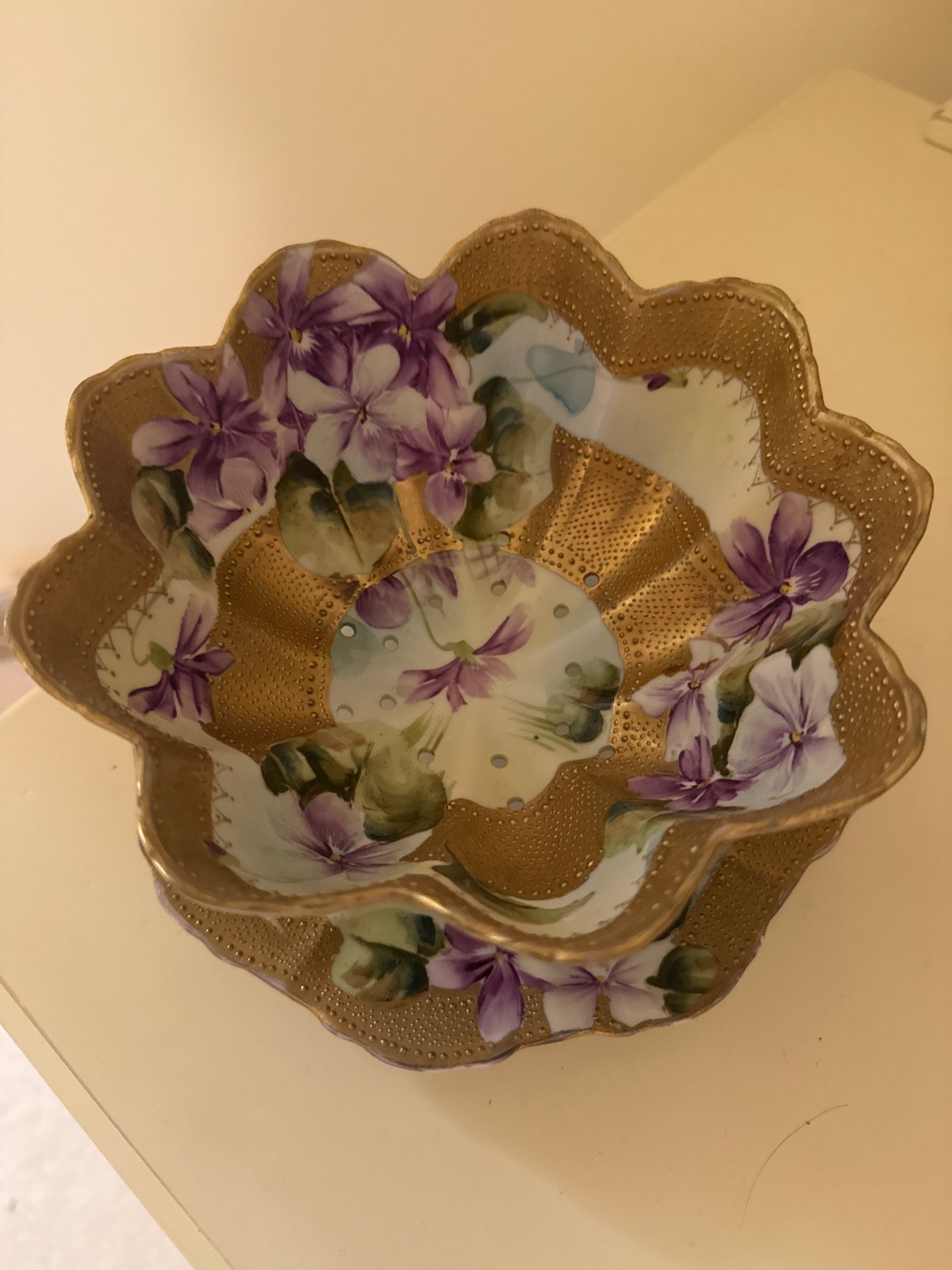 This is an antique hand-painted porcelain berry or dessert bowl.