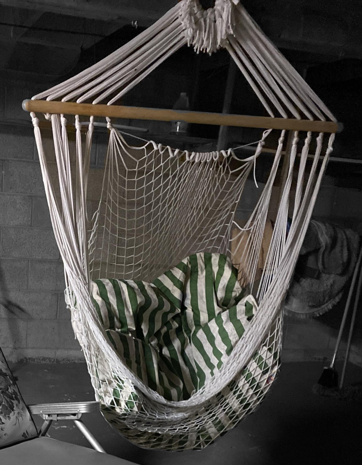 Vintage Bohemian Style Rope Hanging Swing Chair with a striped cushion