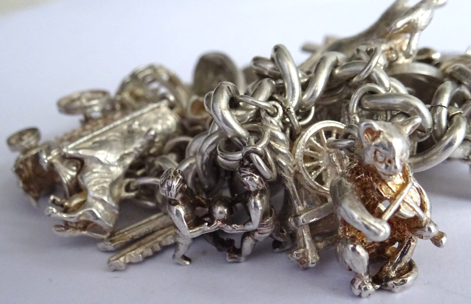 Vintage 102.5g solid silver charm bracelet,many curious silver charms inc moving