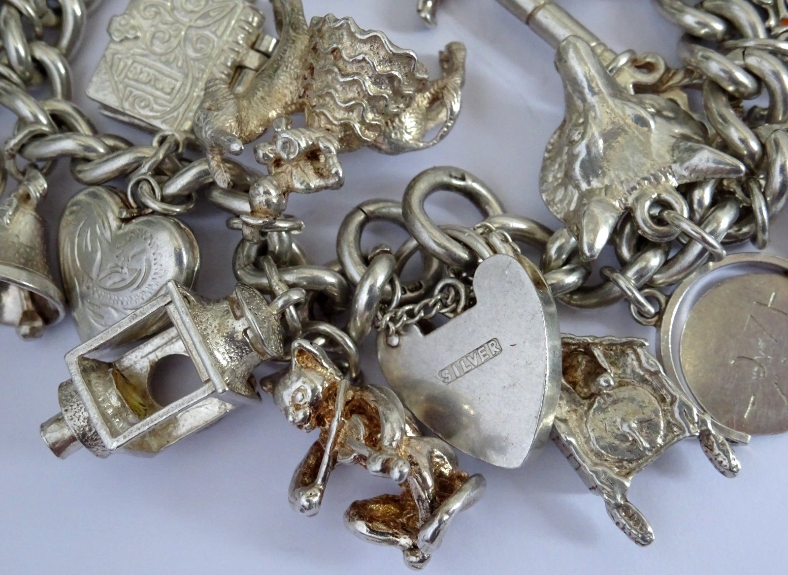 Vintage 102.5g solid silver charm bracelet,many curious silver charms inc moving