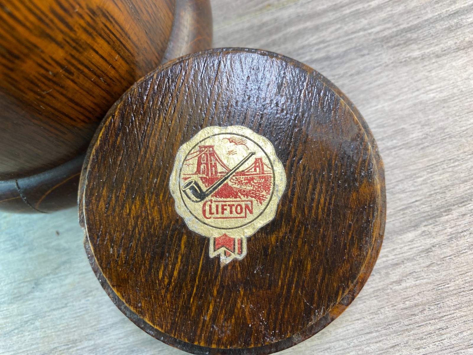An early 20th century turned oak lidded tobacco jar with ceramic liner.