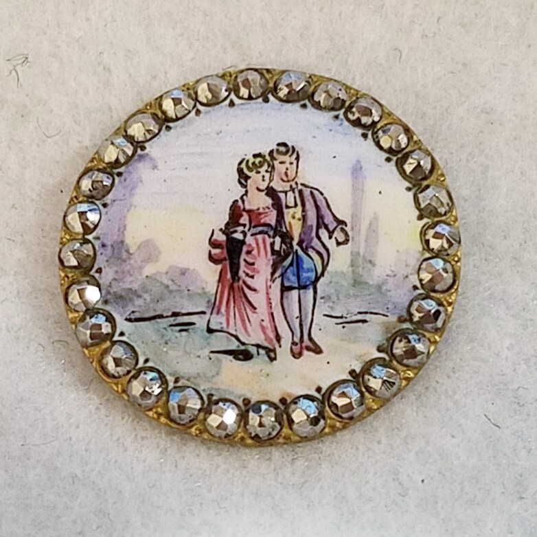 GORGEOUS ANTIQUE PAINTED ENAMEL W/A COUPLE SCENE AND A CUT STEEL BORDER 1-1/18″
