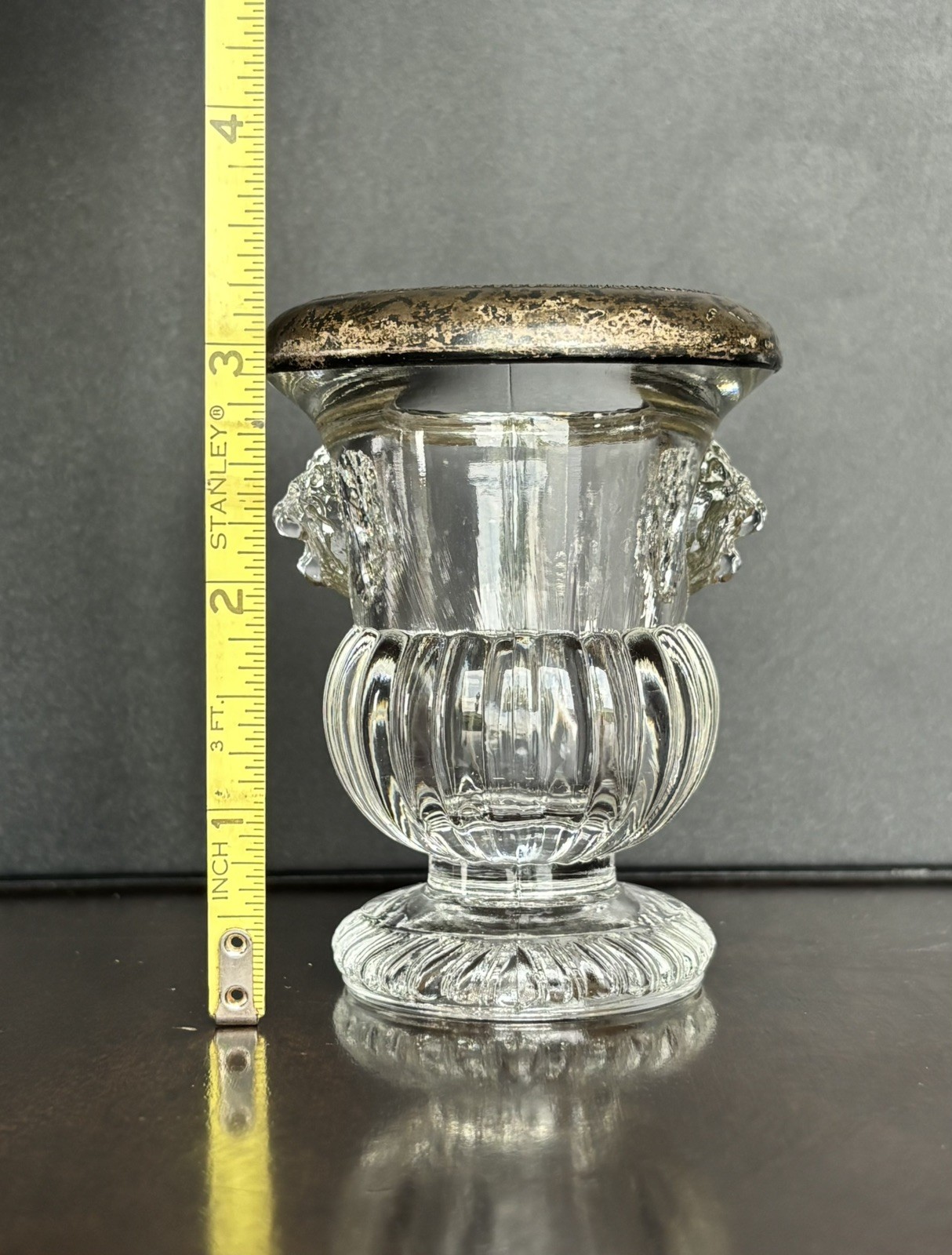 F.B Roger pressed glass toothpick holder with a silver rim and molded lion heads