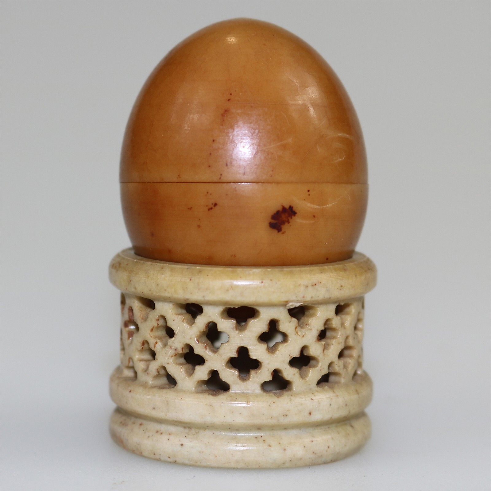 An unusual antique oriental threaded carved nut box on hardstone stand C.1900