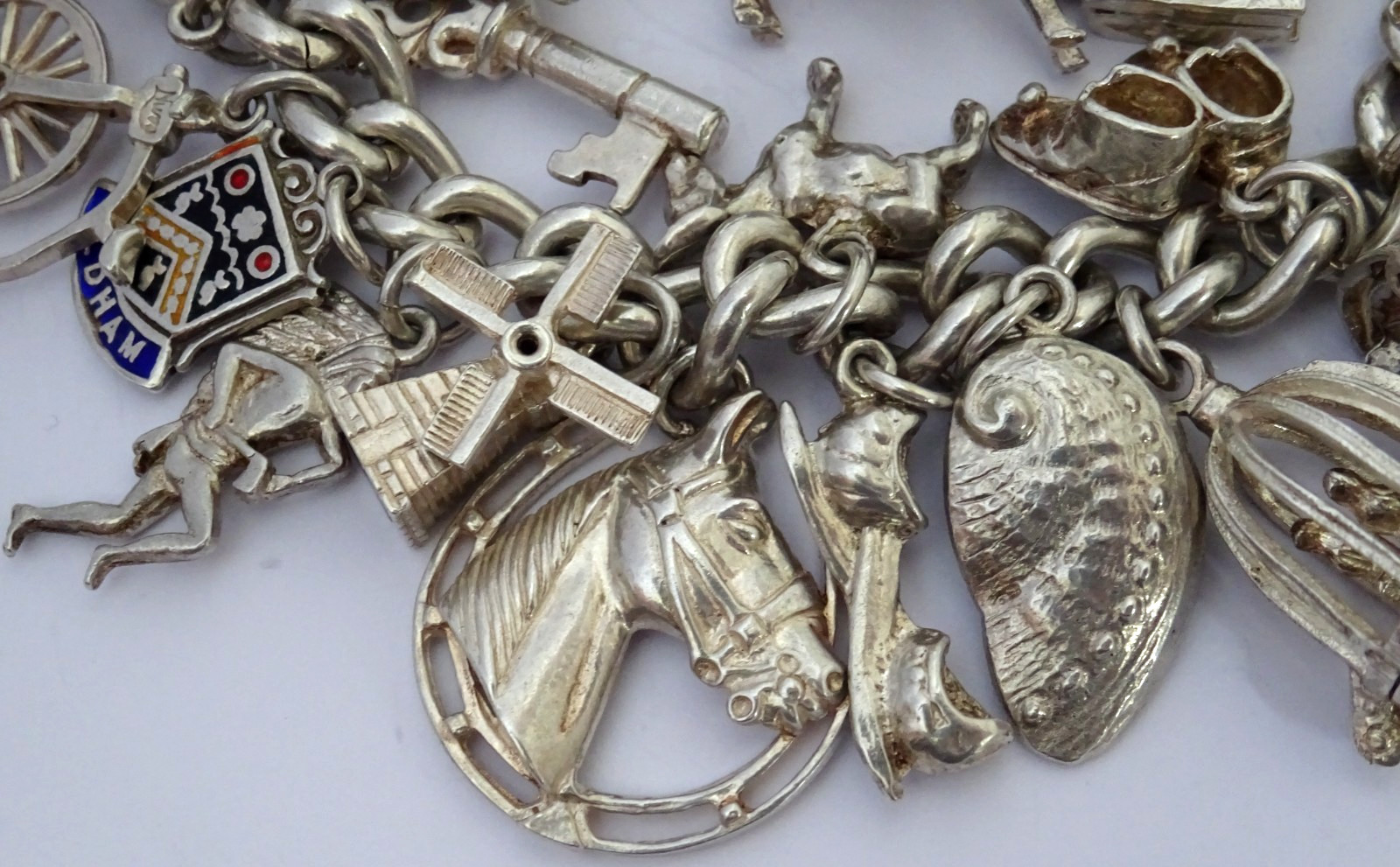 Vintage 102.5g solid silver charm bracelet,many curious silver charms inc moving