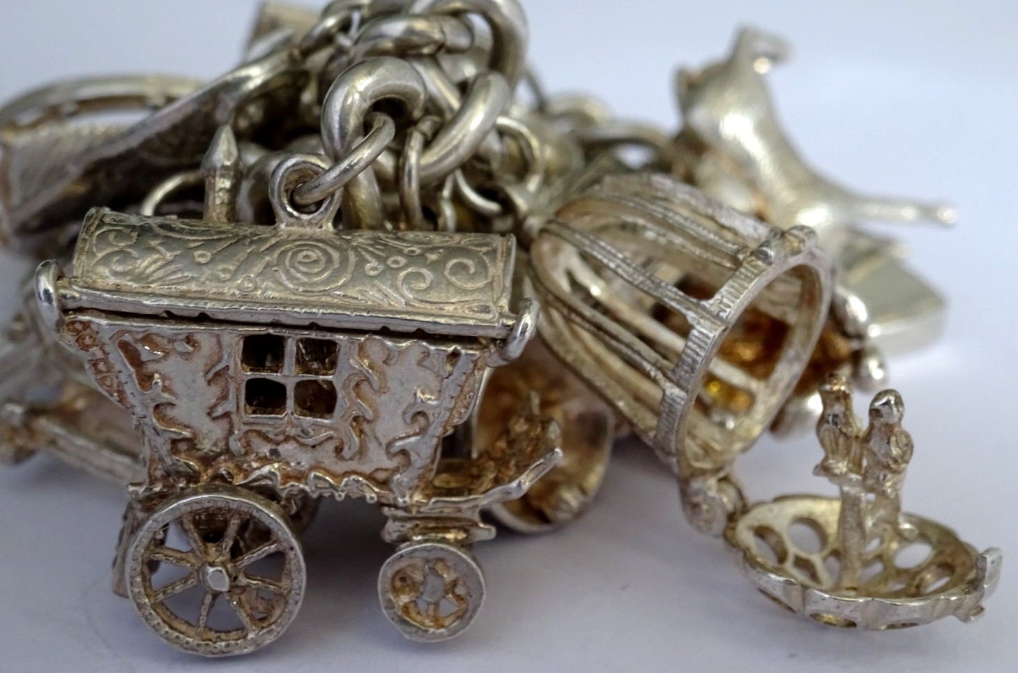 Vintage 102.5g solid silver charm bracelet,many curious silver charms inc moving