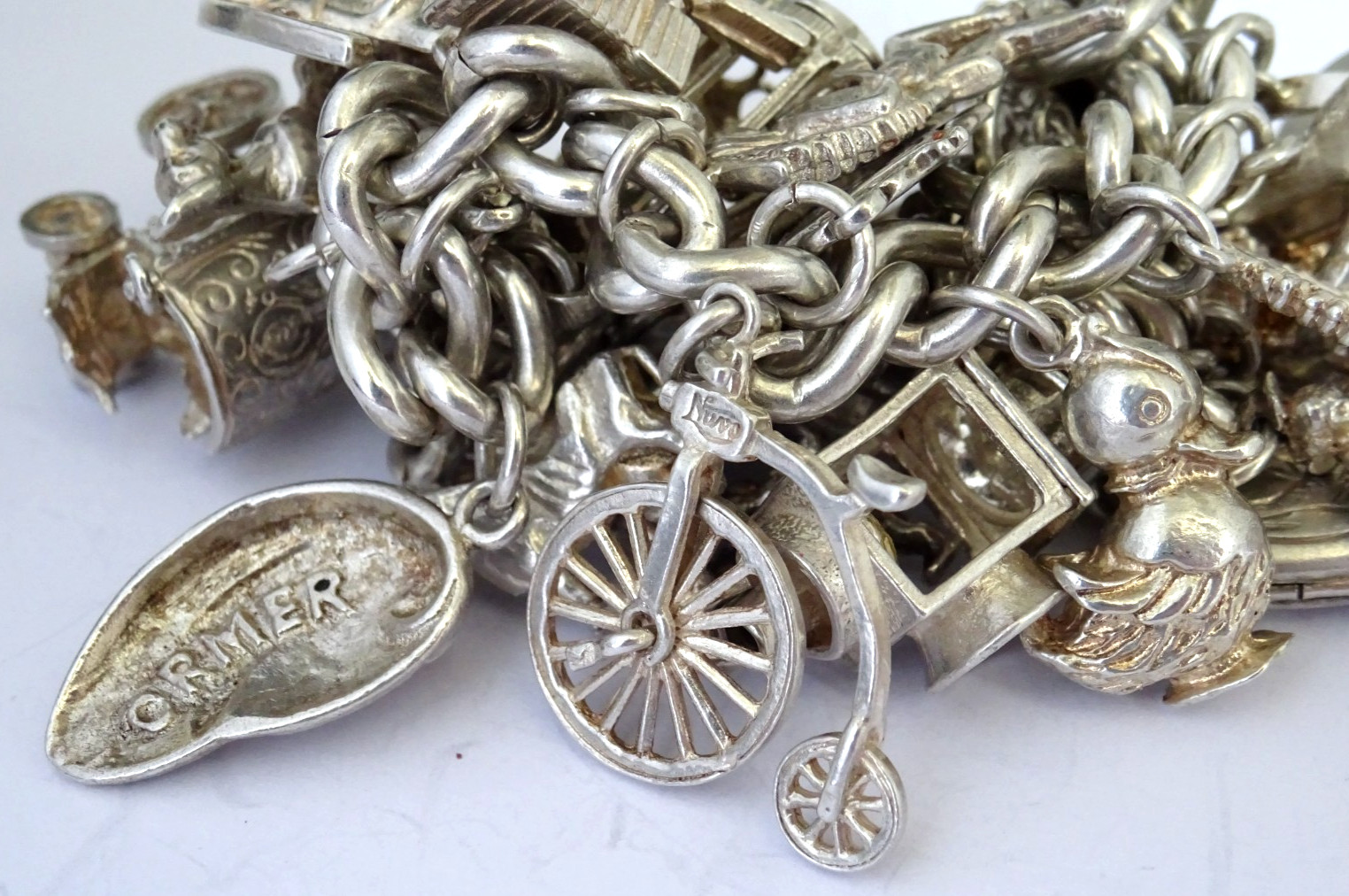 Vintage 102.5g solid silver charm bracelet,many curious silver charms inc moving