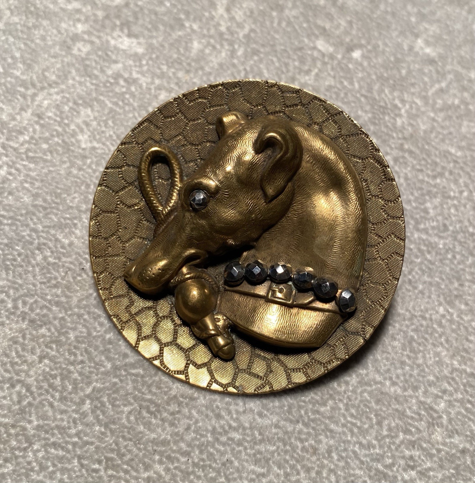 Large antique brass button with whipped biting a whip with steel face collar 2”