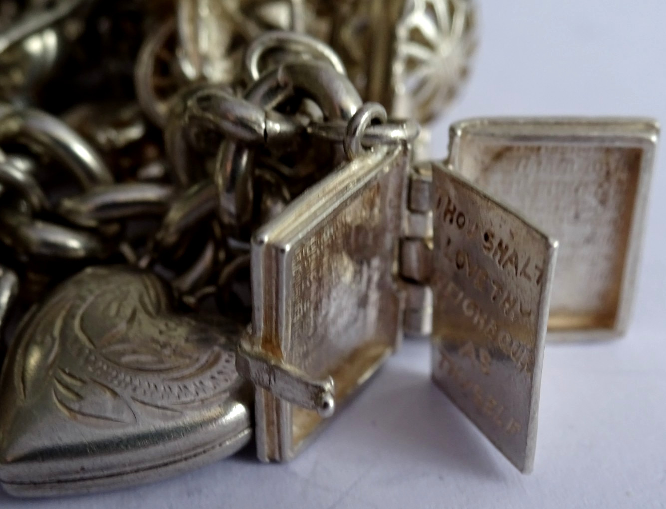 Vintage 102.5g solid silver charm bracelet,many curious silver charms inc moving