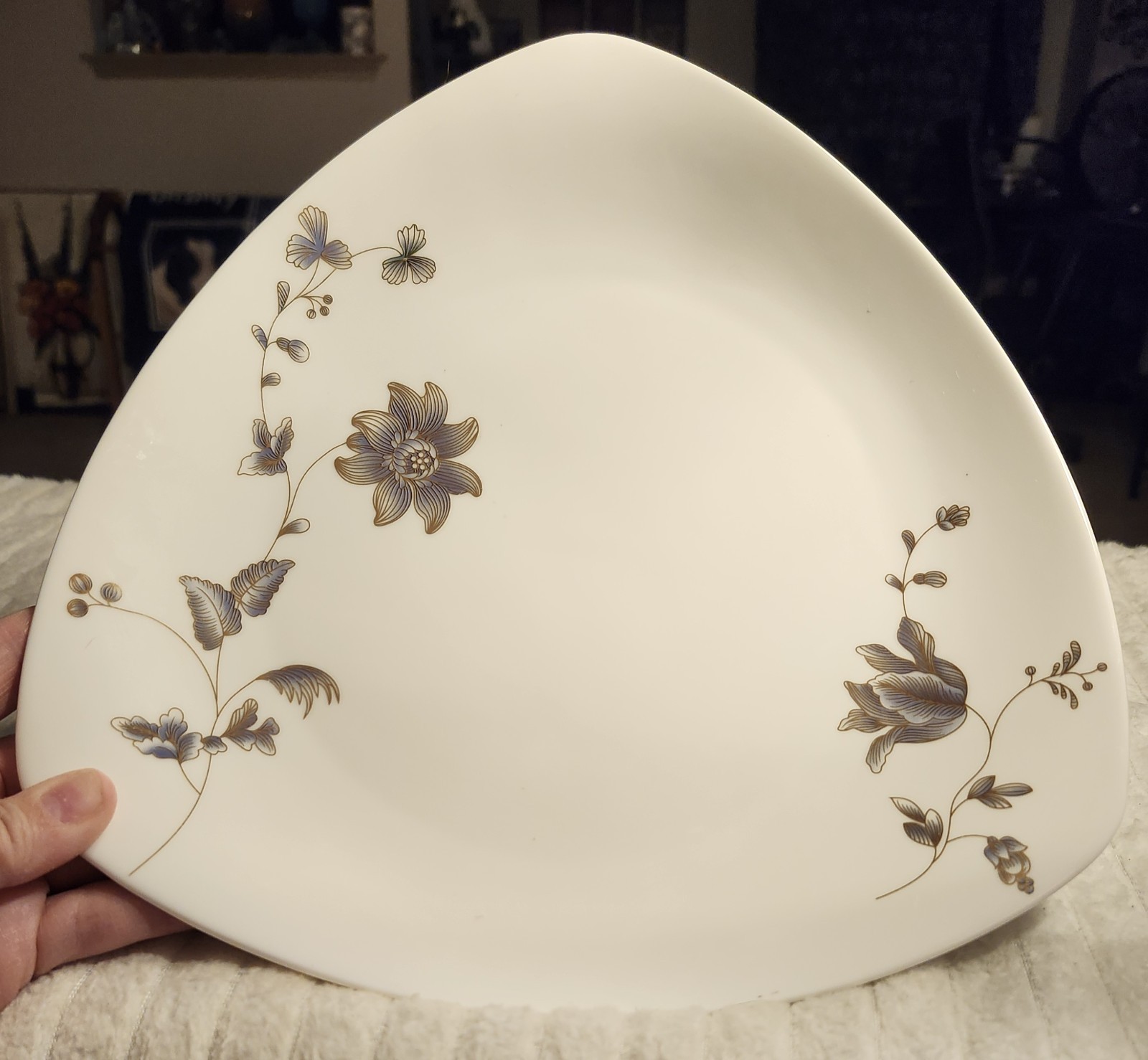 A “Henniger House of Luxury” triangular plate with a blue and gold floral…