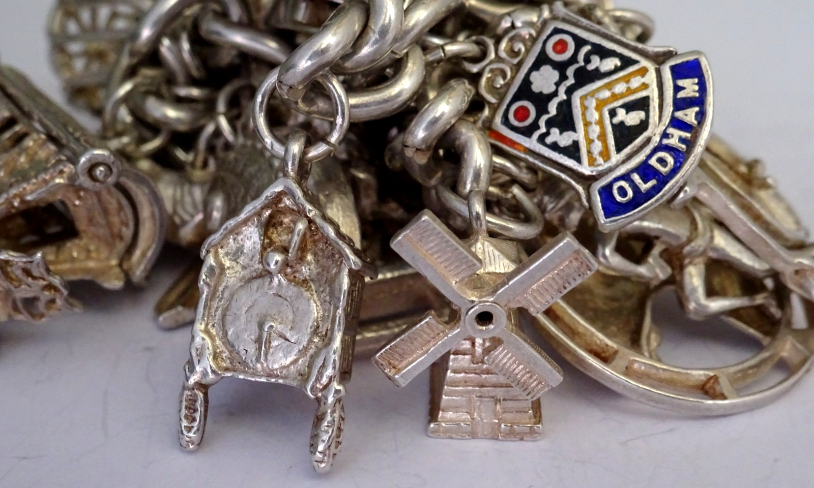 Vintage 102.5g solid silver charm bracelet,many curious silver charms inc moving