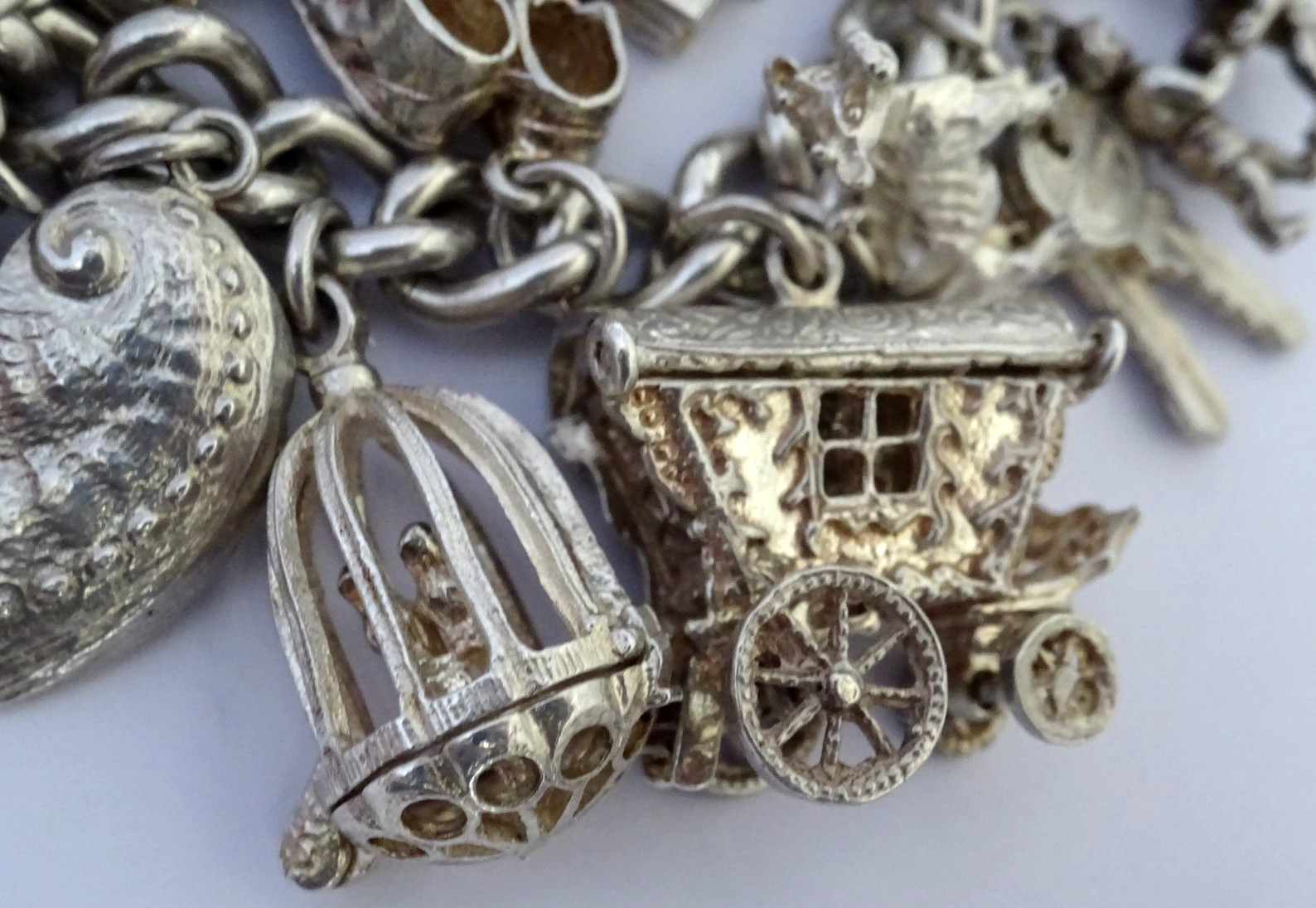 Vintage 102.5g solid silver charm bracelet,many curious silver charms inc moving