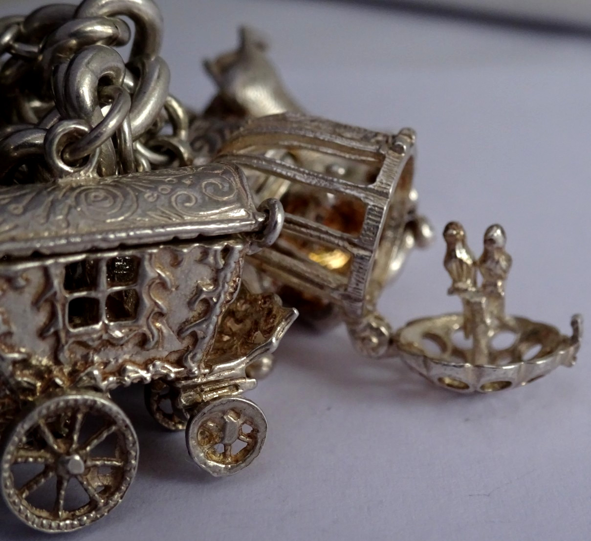 Vintage 102.5g solid silver charm bracelet,many curious silver charms inc moving
