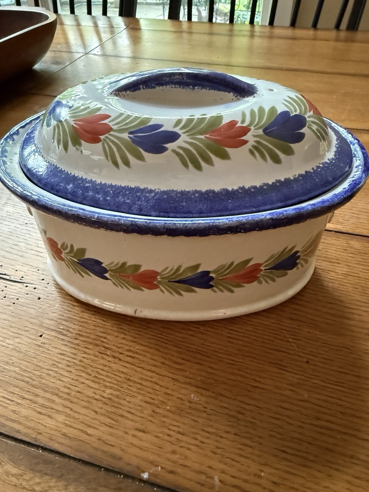 Vintage hand painted floral enamelware covered casserole dish. Blue rim folk art