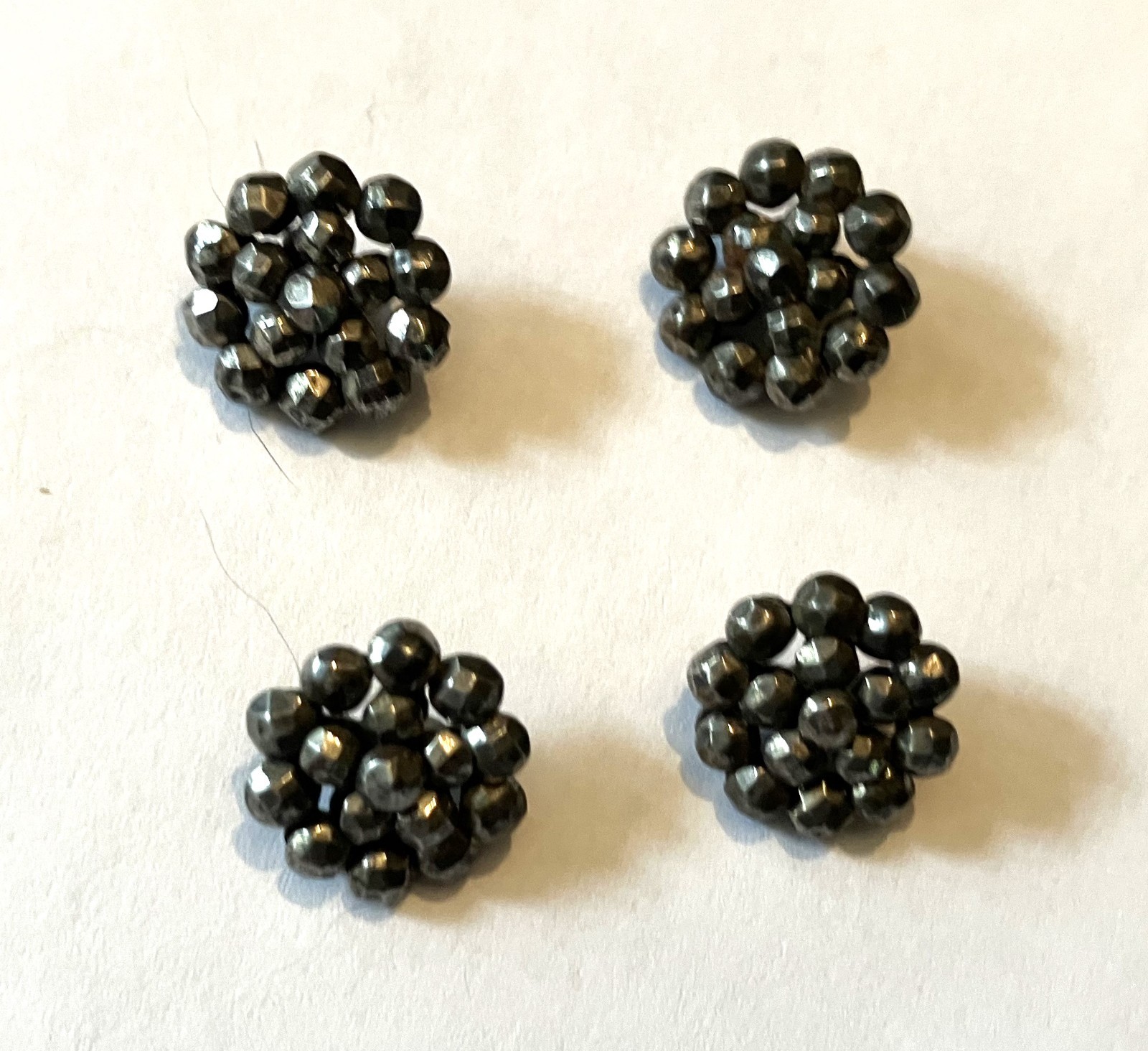 4 Antique Riveted Cut Steel Openwork Metal Buttons Attached to a Brass Back.
