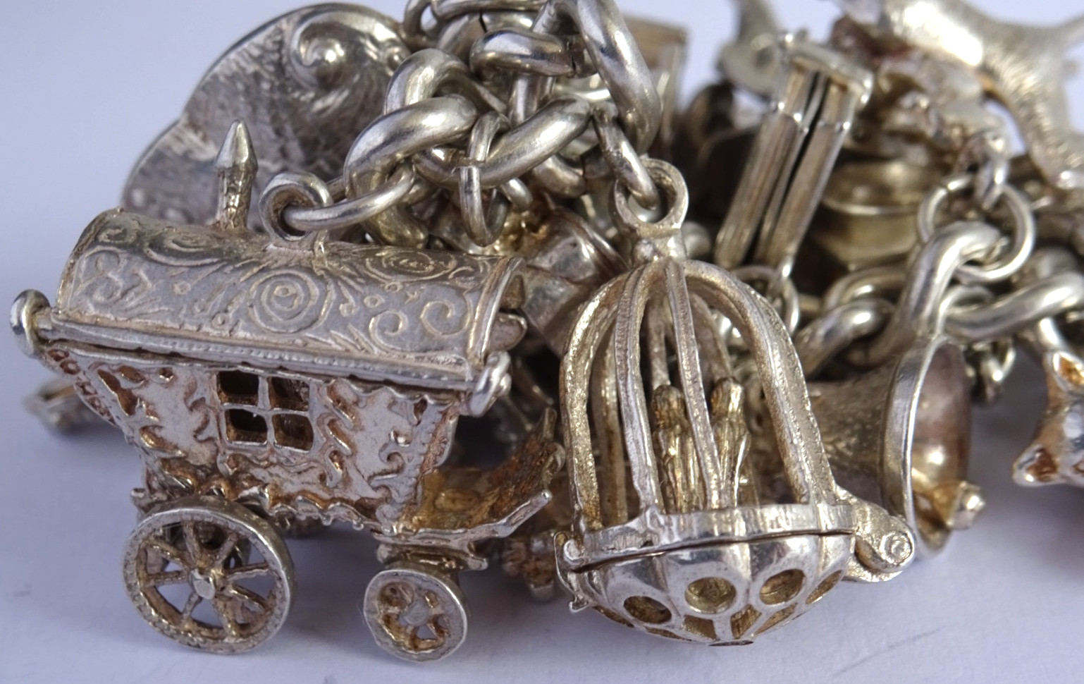 Vintage 102.5g solid silver charm bracelet,many curious silver charms inc moving