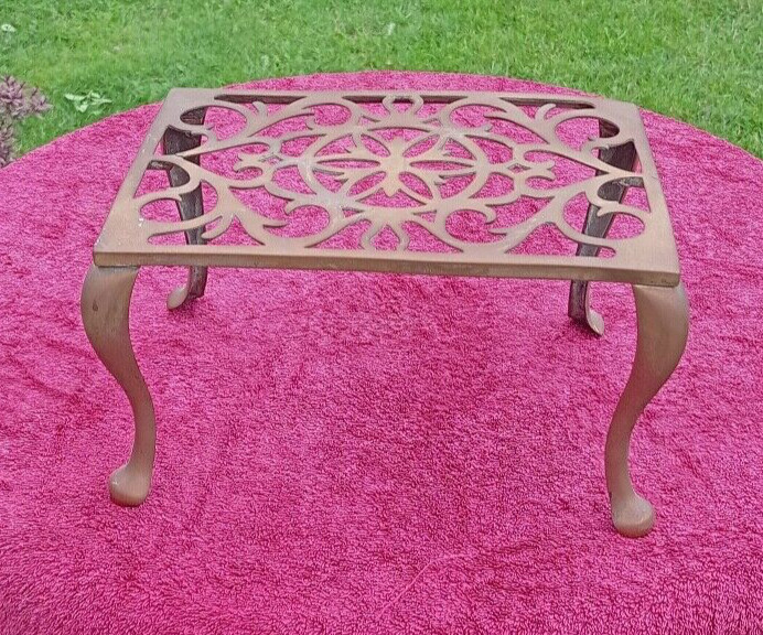 A large late 19th early 20th century brass trivet pot stand or hearth stand