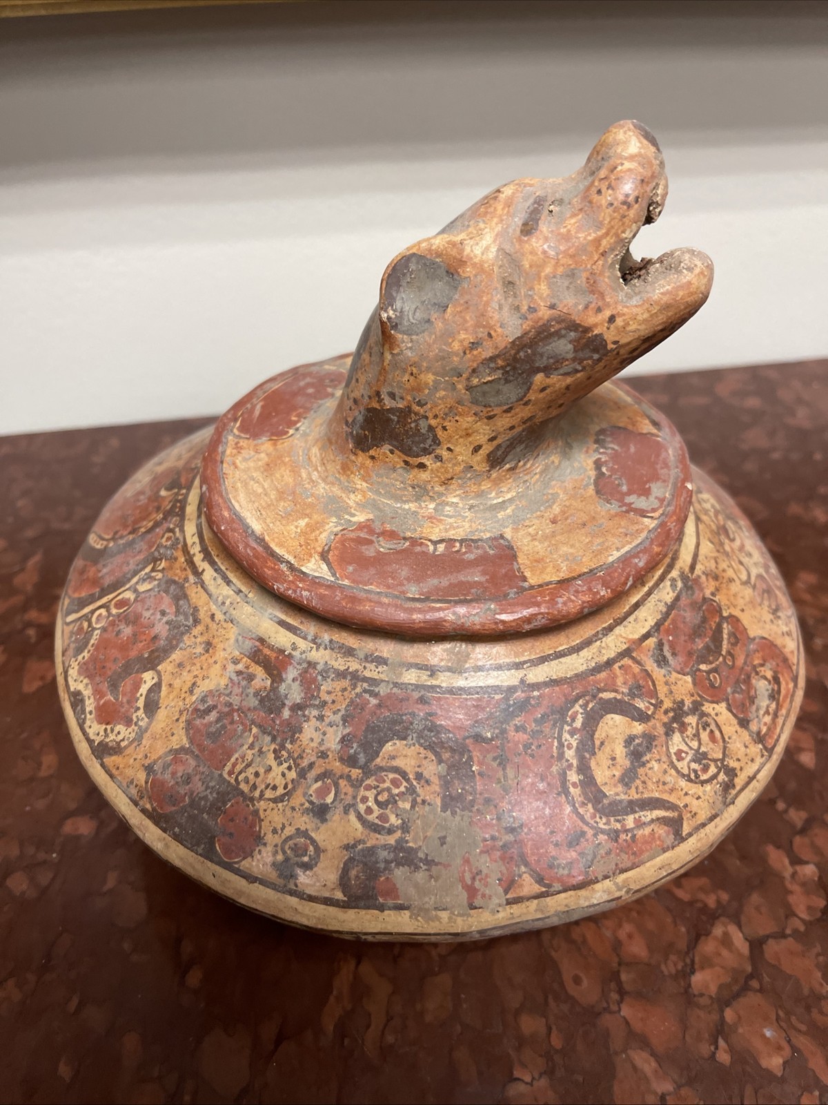 Maya polychrome ceramic effigy vessel with jaguar head spout.