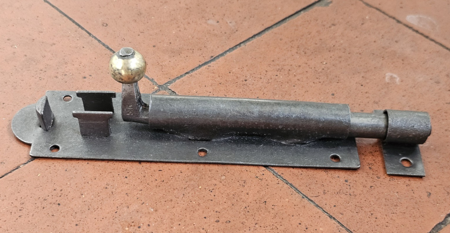 Antique Victorian black iron and brass door bolt with surface mounted keep 1880