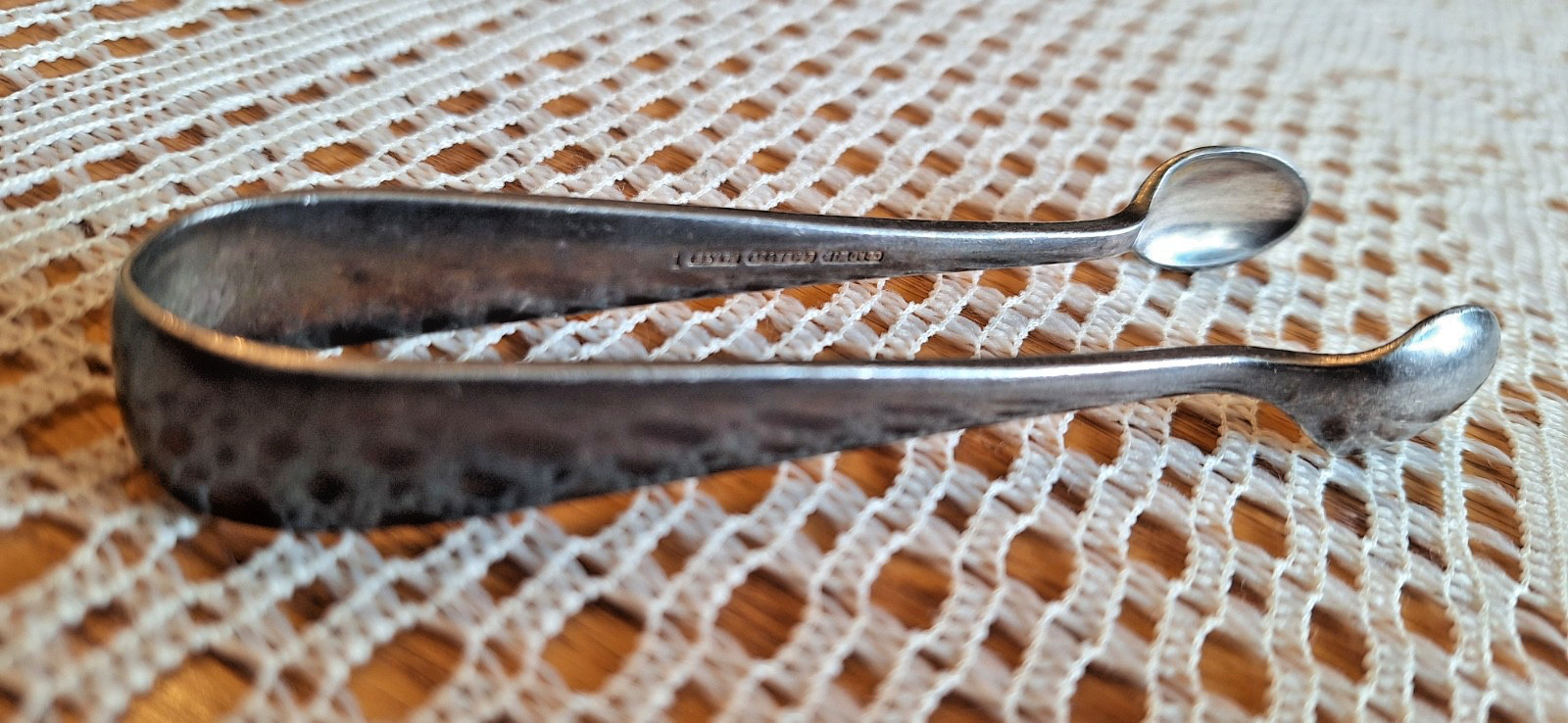 silver plate sugar tongs. J LYONS