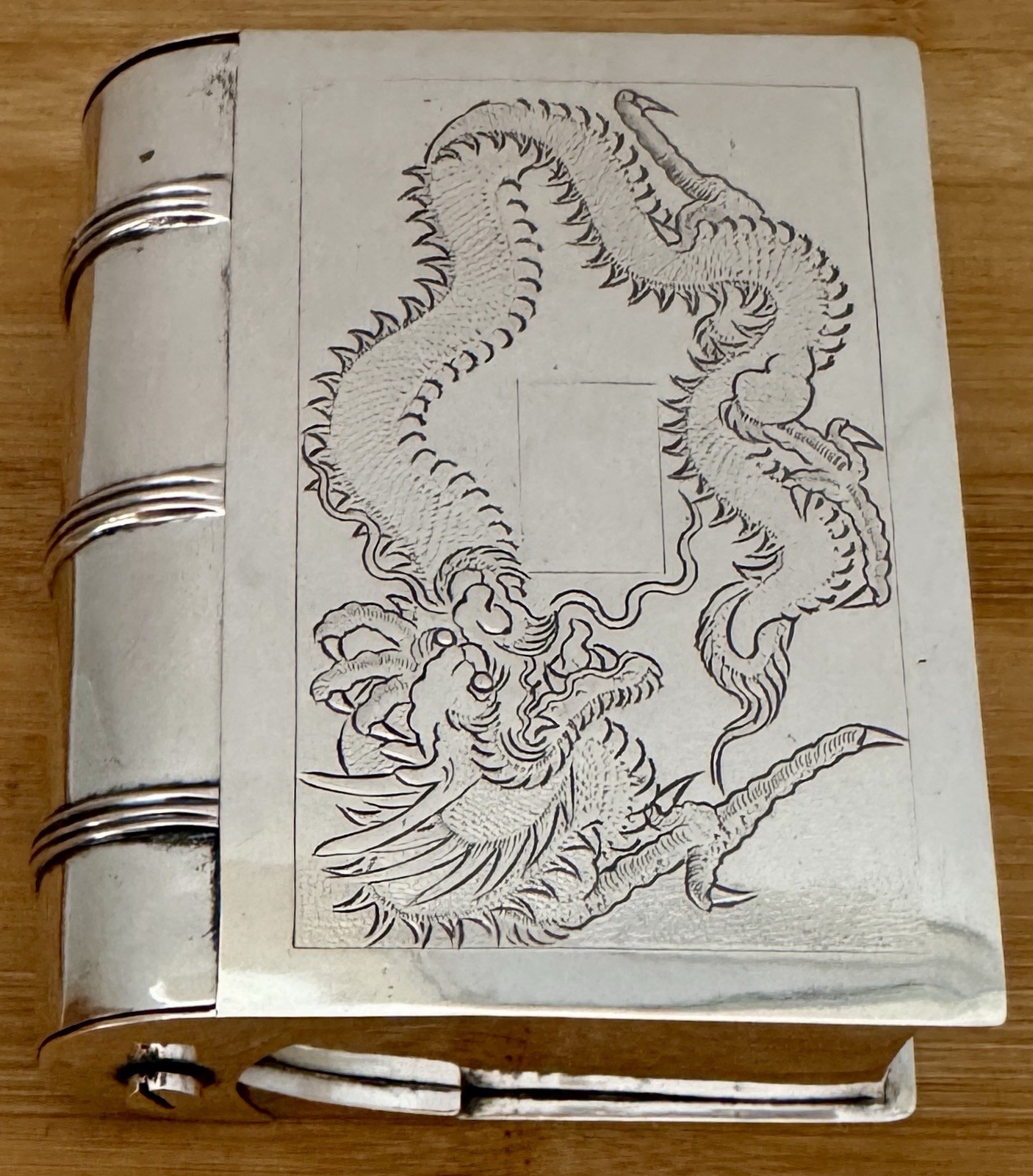 FIGURAL BOOK FORM STERLING SILVER TABLE BOX WITH ENGRAVED DRAGON ON IT’S LID