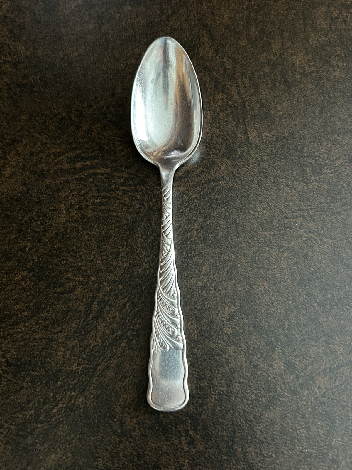 Dillon & Co. teaspoon- silver plate- swirl pattern front and back- small rub