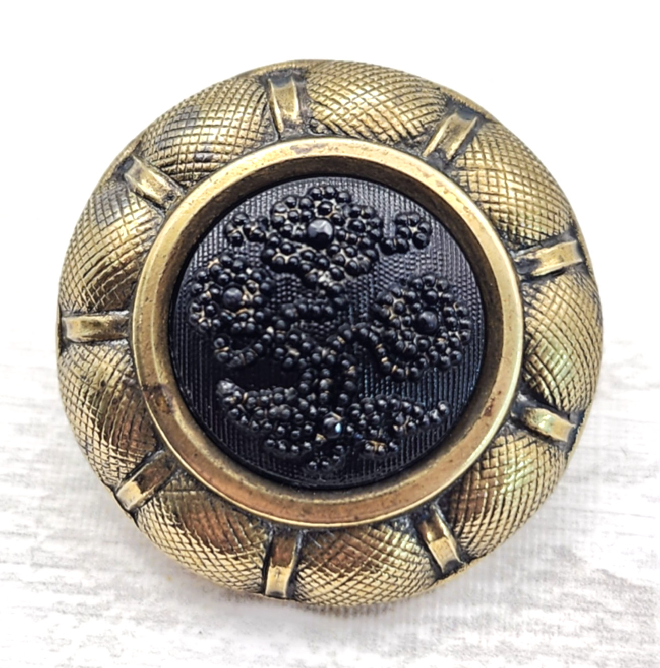 Antique Black Glass in Metal Button ~ Relief Glass Floral w/ Brass Border ~ 1″