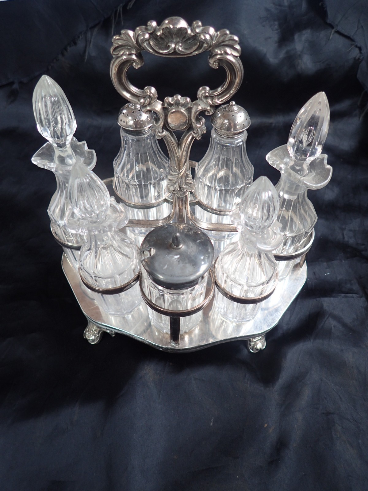 ANTIQUE GLASS AND SILVERPLATE CASTOR CRUET SET 7 BOTTLES ALL MATCHING