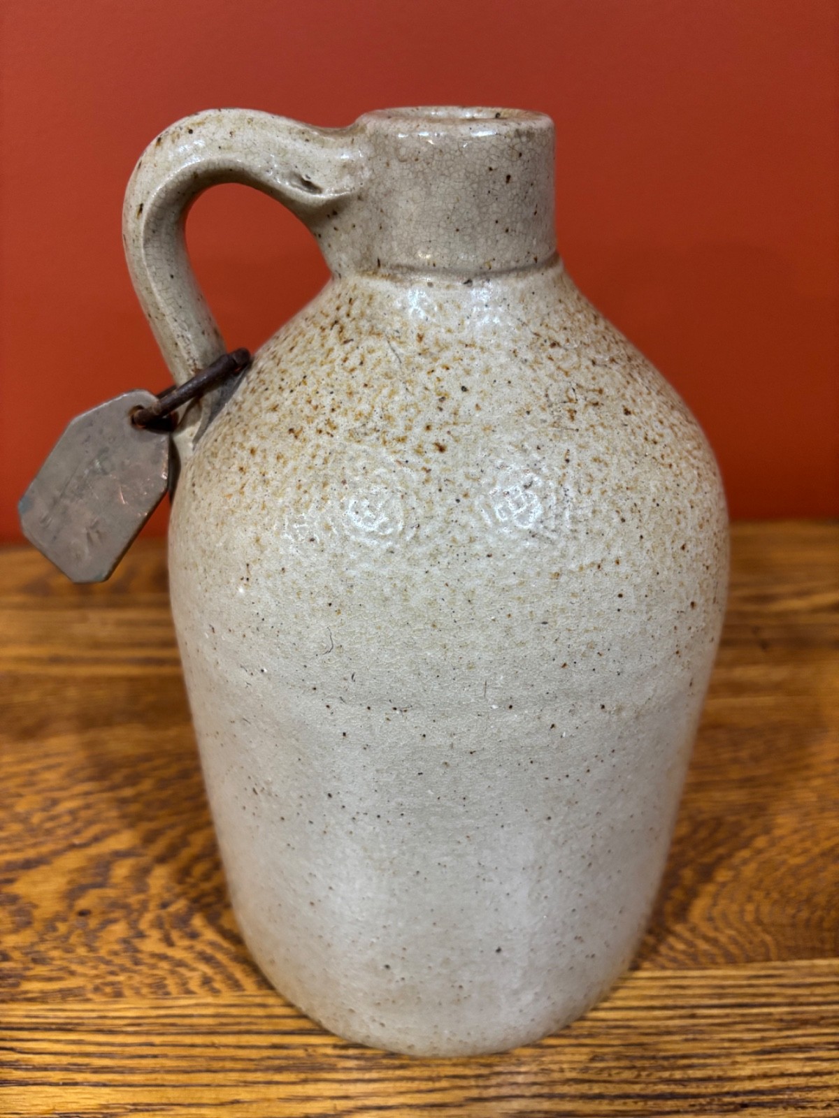 1 /2 GALLON STONEWARE JUG WITH COPPER TAG
