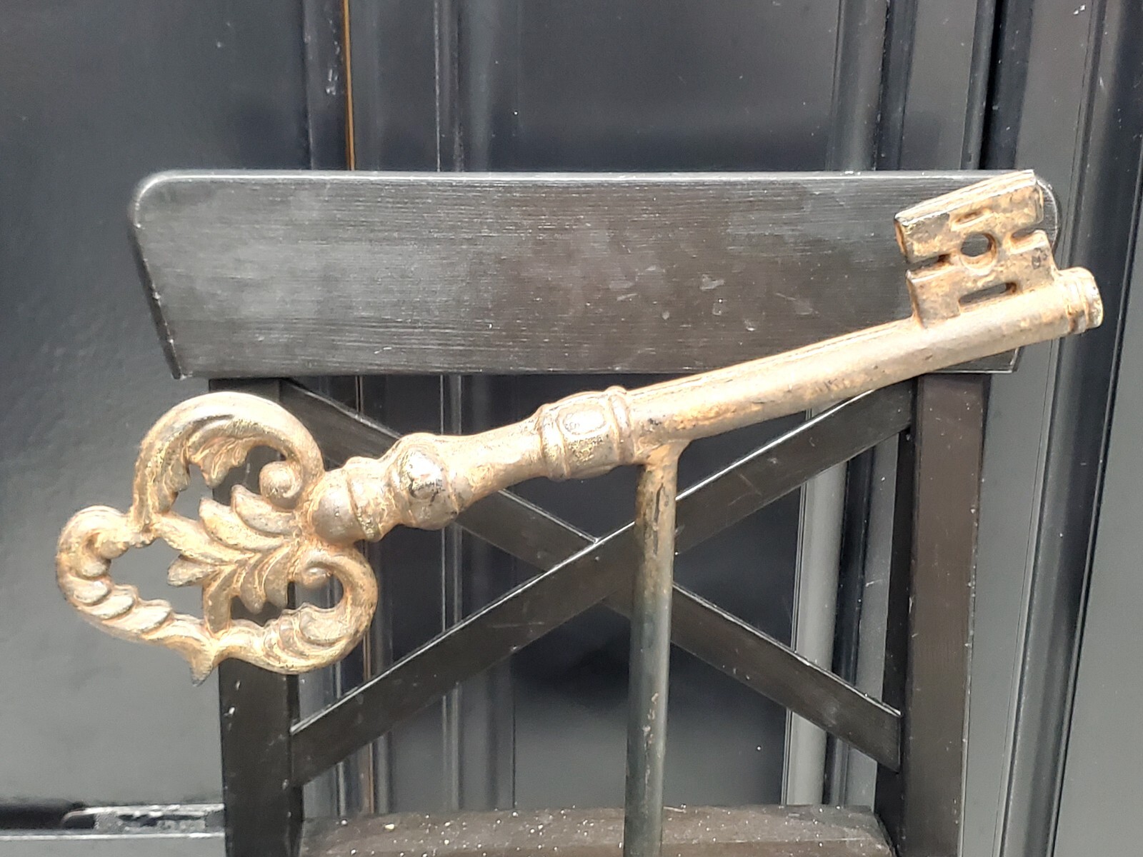 13in Antique Large solid cast iron key heavy on stand. Old church castle palace?