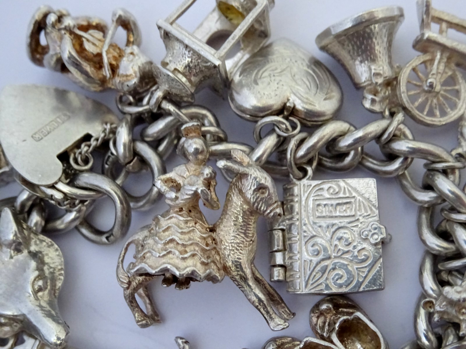 Vintage 102.5g solid silver charm bracelet,many curious silver charms inc moving