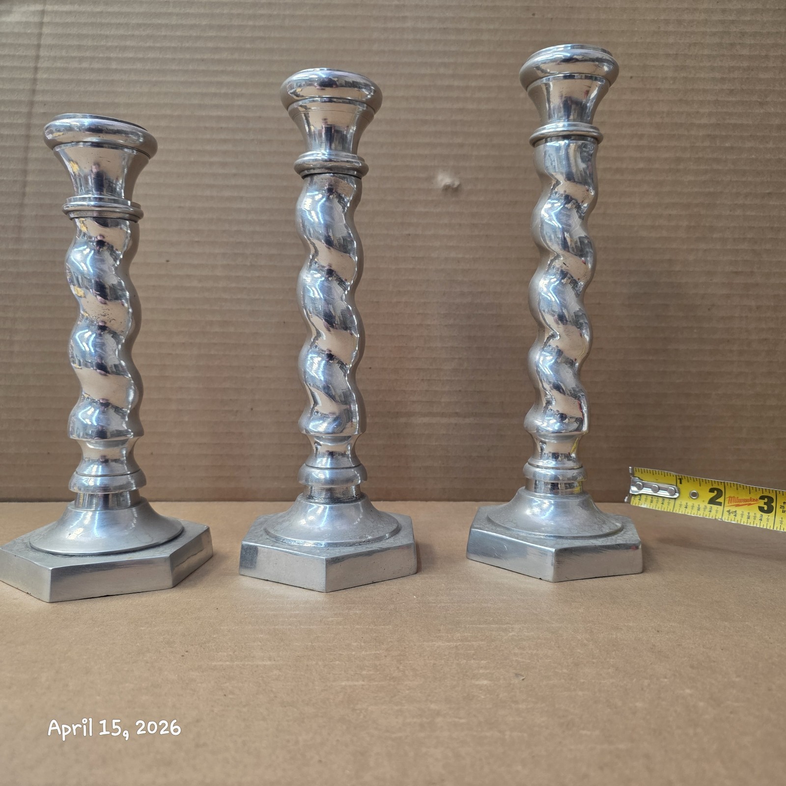 Set of three candlesticks, silver plated. 10.25 in, 9.75 in, 8.75 in.