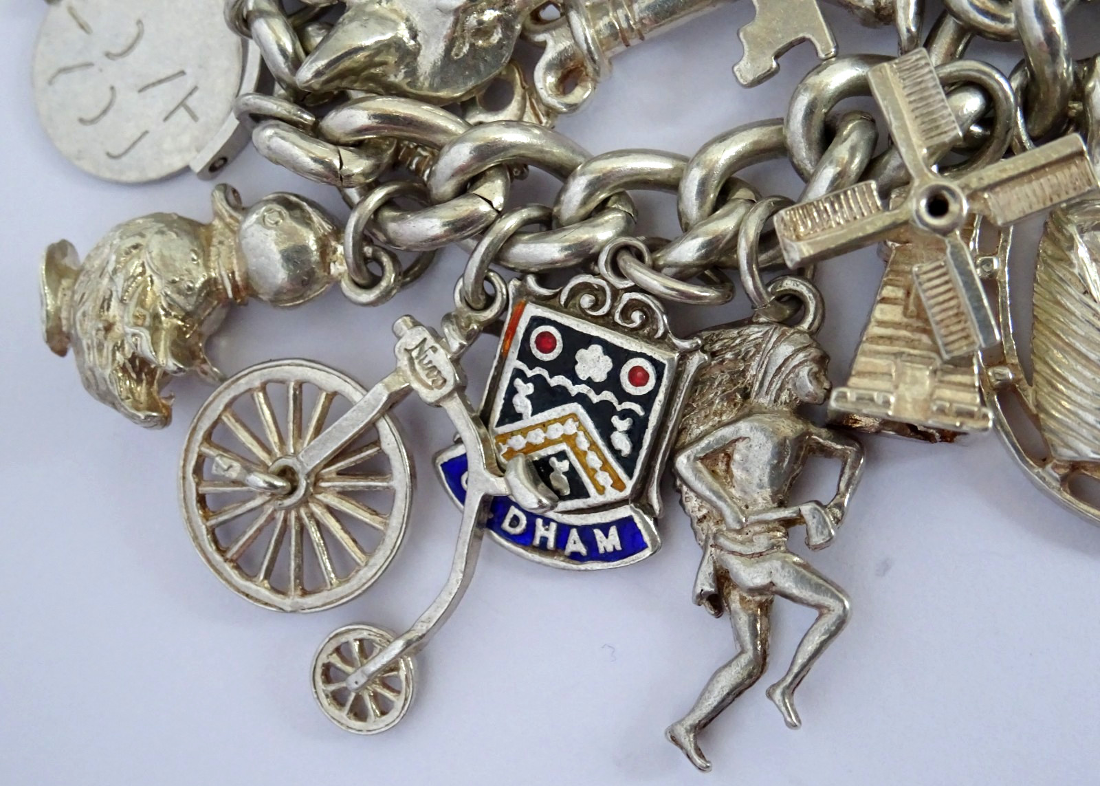 Vintage 102.5g solid silver charm bracelet,many curious silver charms inc moving