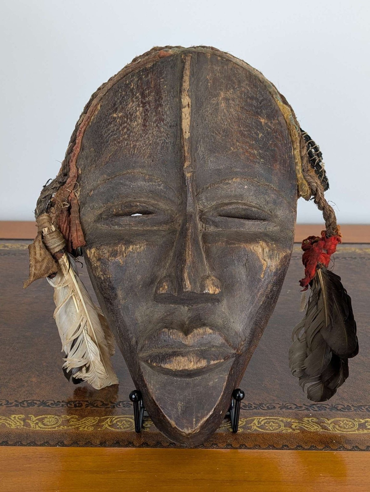 Dan gle ceremonial mask with feathers and woven fibre trim, wood-carved, African