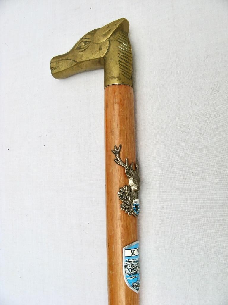 Walking stick with brass horse’s head handle & stag’s head and souvenir badges