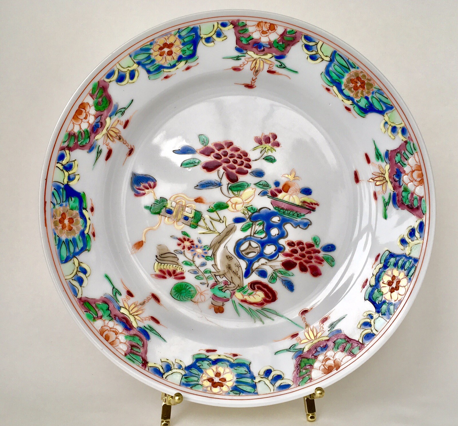 A Chinese famille rose plate decorated with a bird. Yongzheng period 18 C Signed
