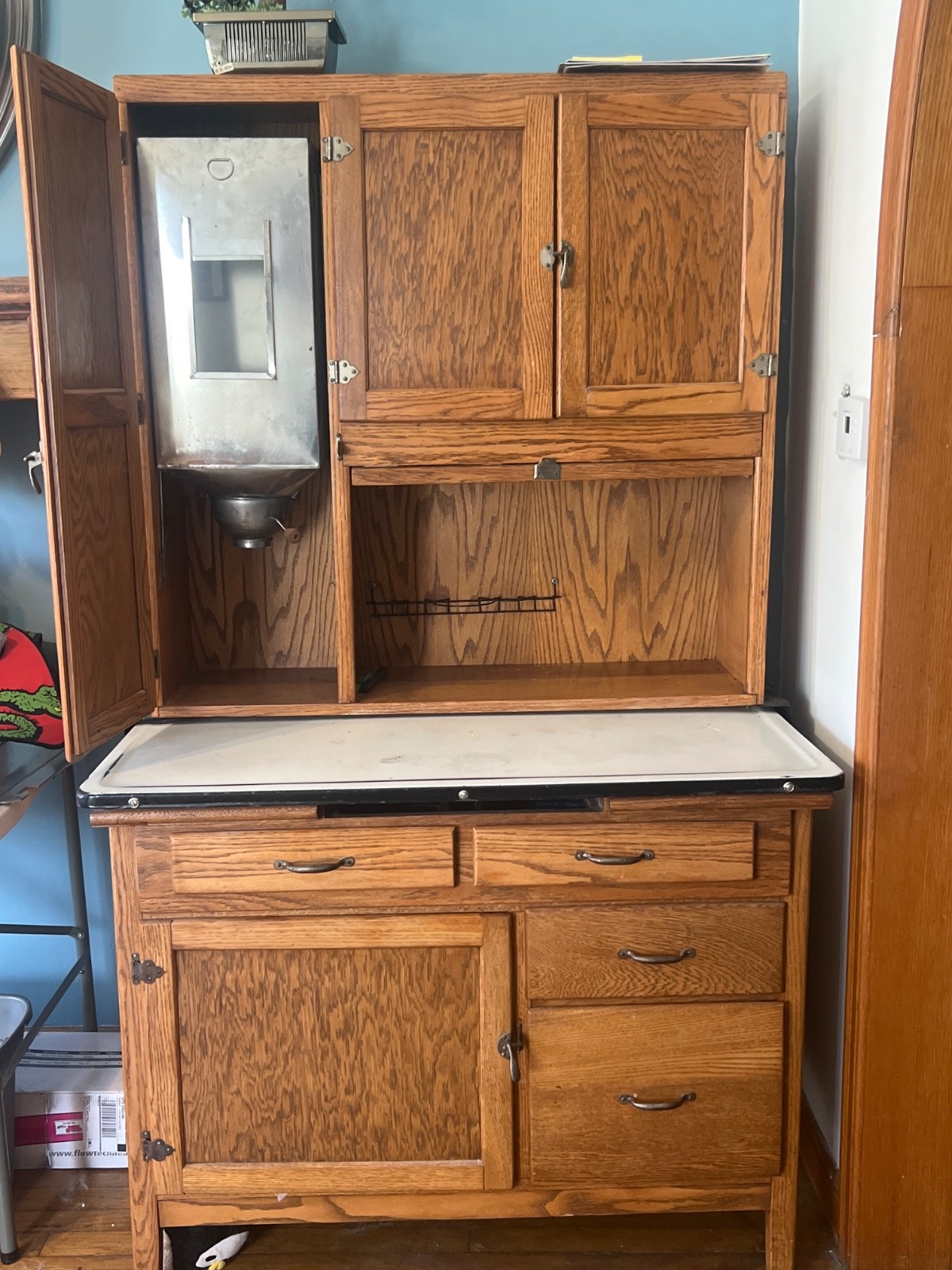 Antique oak Hoosier kitchen cabinet with pull-out work surface.